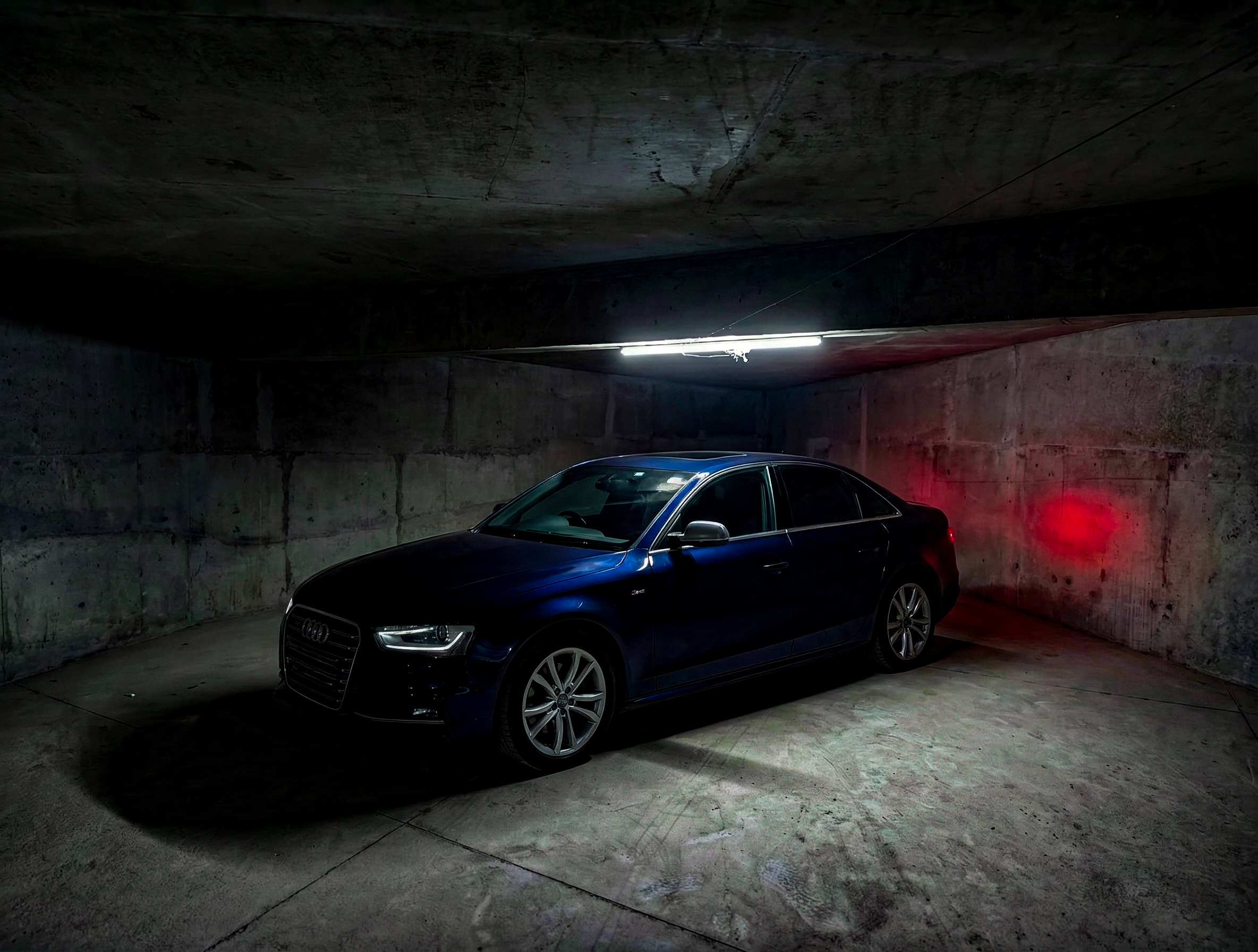 Blue Audi performance sedan in an underground garage